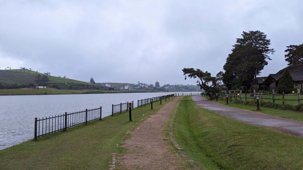 View from the park next to Gregory Lake with a walking path on the right and the lake to the left.