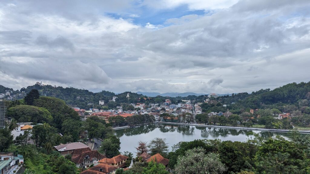 View of Kandy from a roadside viewpoint on a hill overlooking the city and the lake.