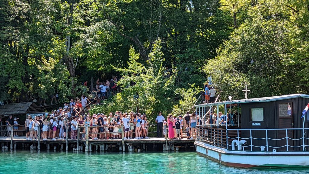 A line of people waiting to get on the boat from Upper Lakes to Lower Lakes at Plitvice Lakes National Park