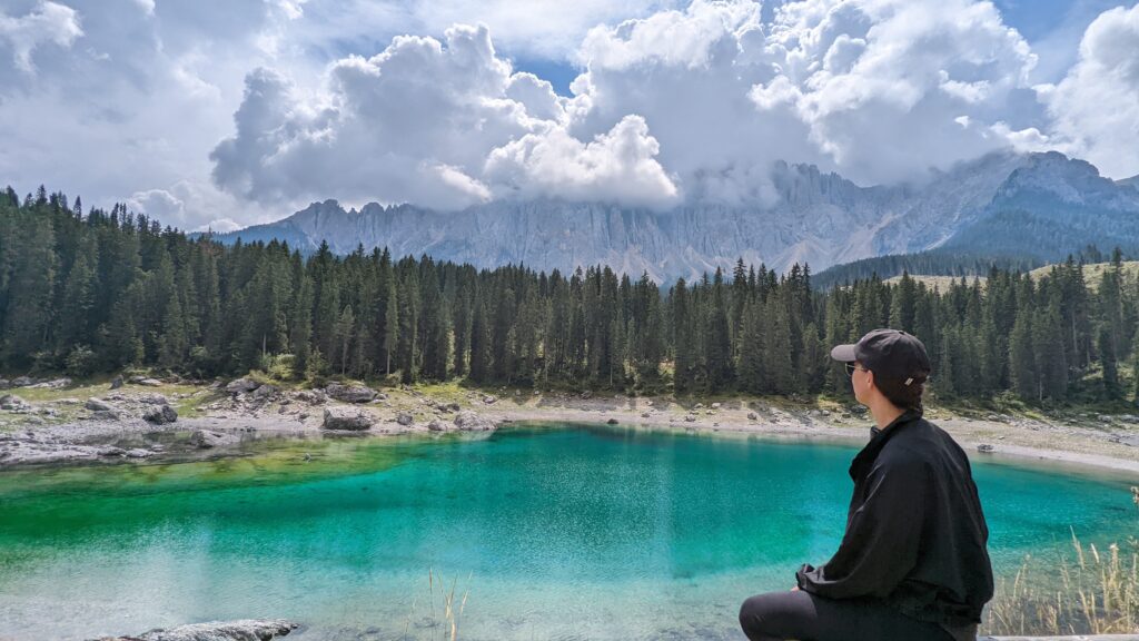 Lago di Carezza (Karersee) with mountain peaks in the background, a must-see in the Dolomites