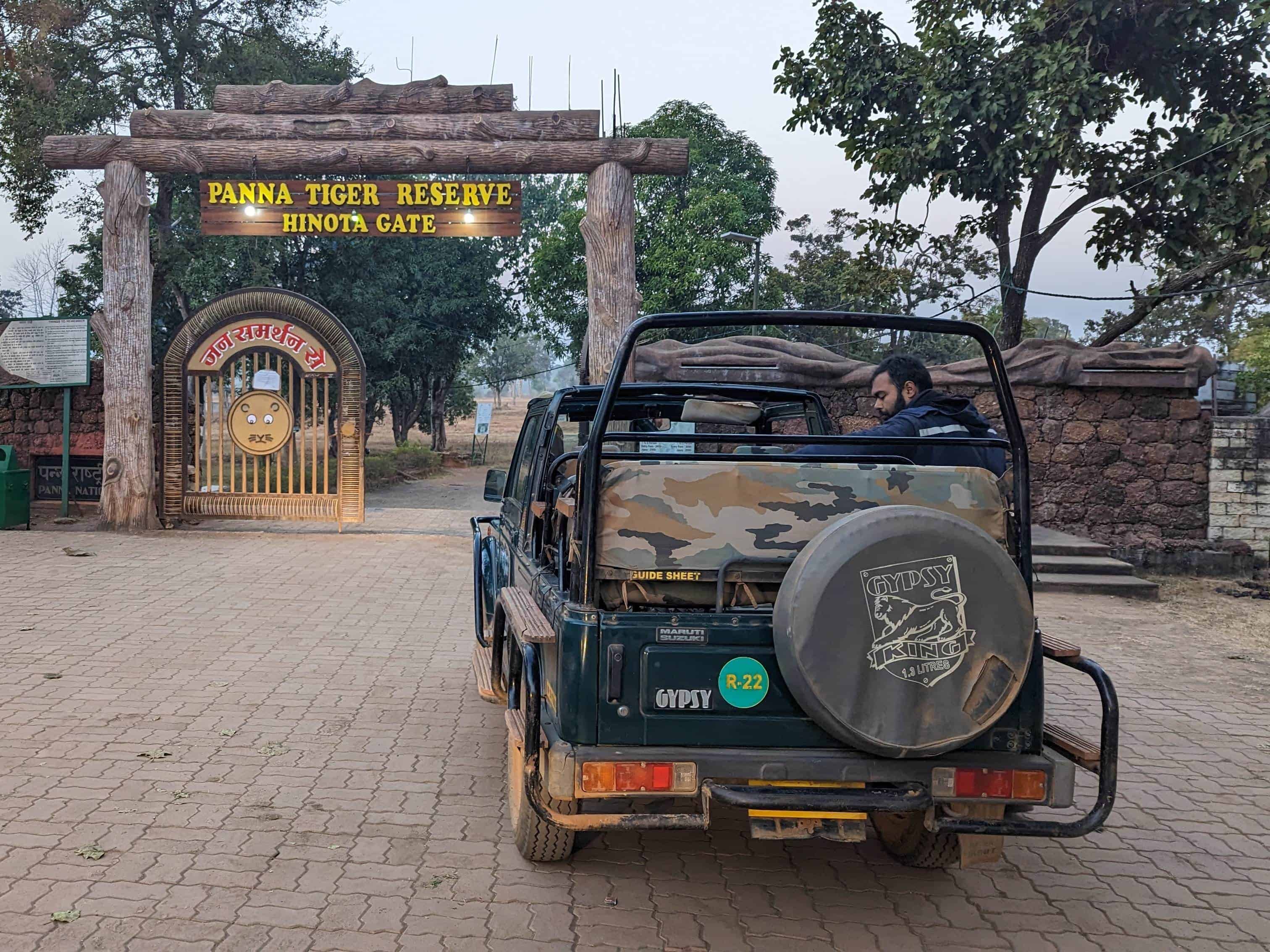 Entrance to Panna National Park at the Hinota Gate with a parked open safari vechicle next to it.