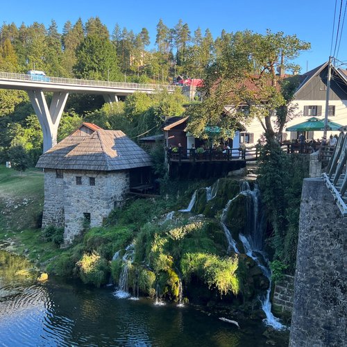 View from roadside overlooking waterfall in Rastoke, Croatia