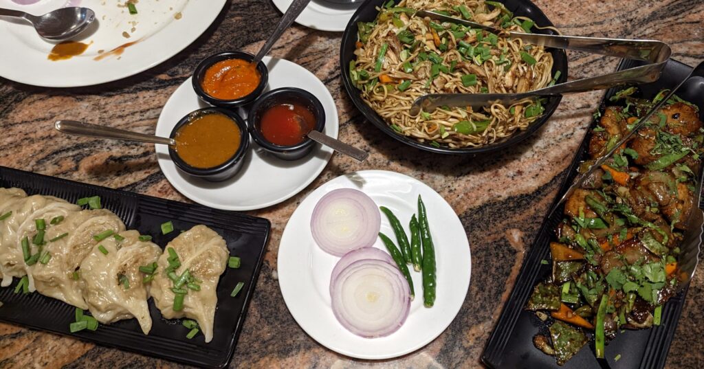 Overhead table picture of chow and moms at Little Chef Spices of Asia, one of Shillong's best restaurants.