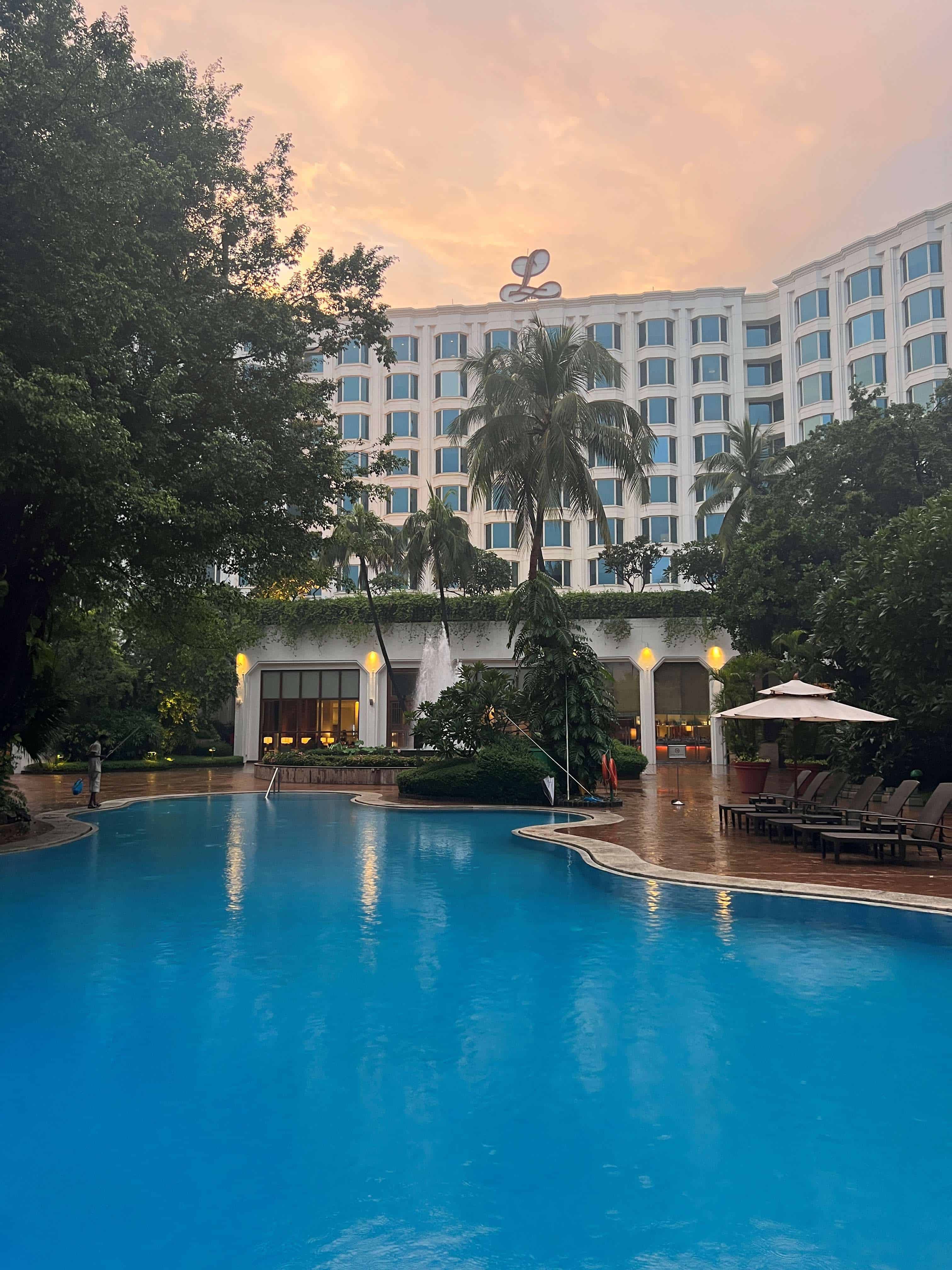 Outside view of the Leela hotel near Mumbai airport from the back of the hotel with the pool in the foreground.