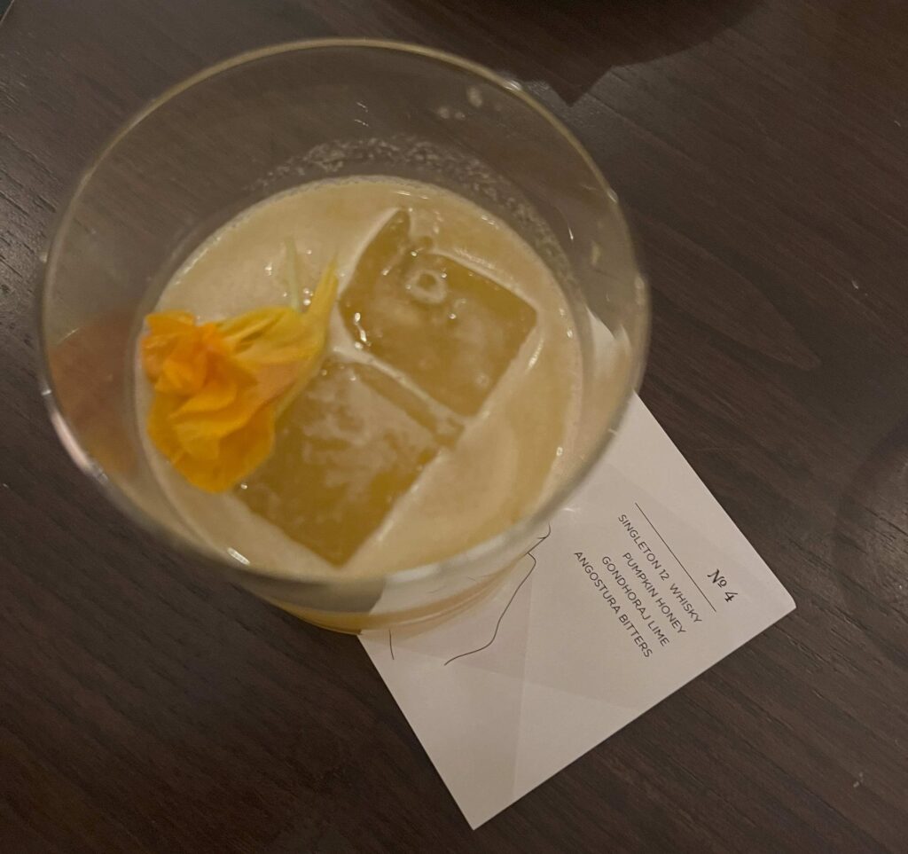 Overhead view of a cocktail with edible flower at Masque Mumbai, India's best restaurant