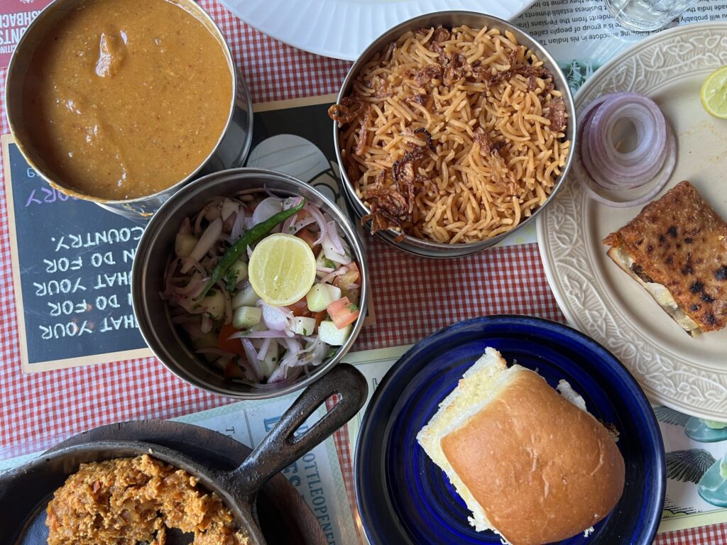 View of table with Parso dishes at SodaBottleOpenerWala