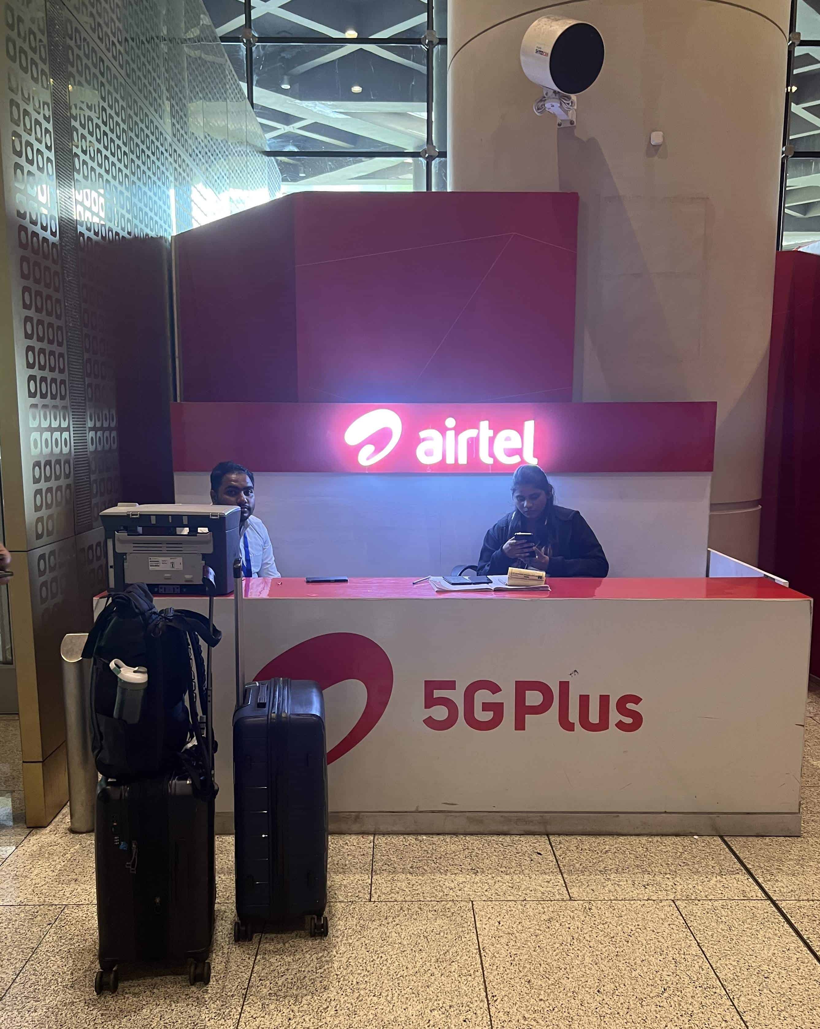 Airtel booth selling SIM cards for travelers in India at Mumbai Airport.