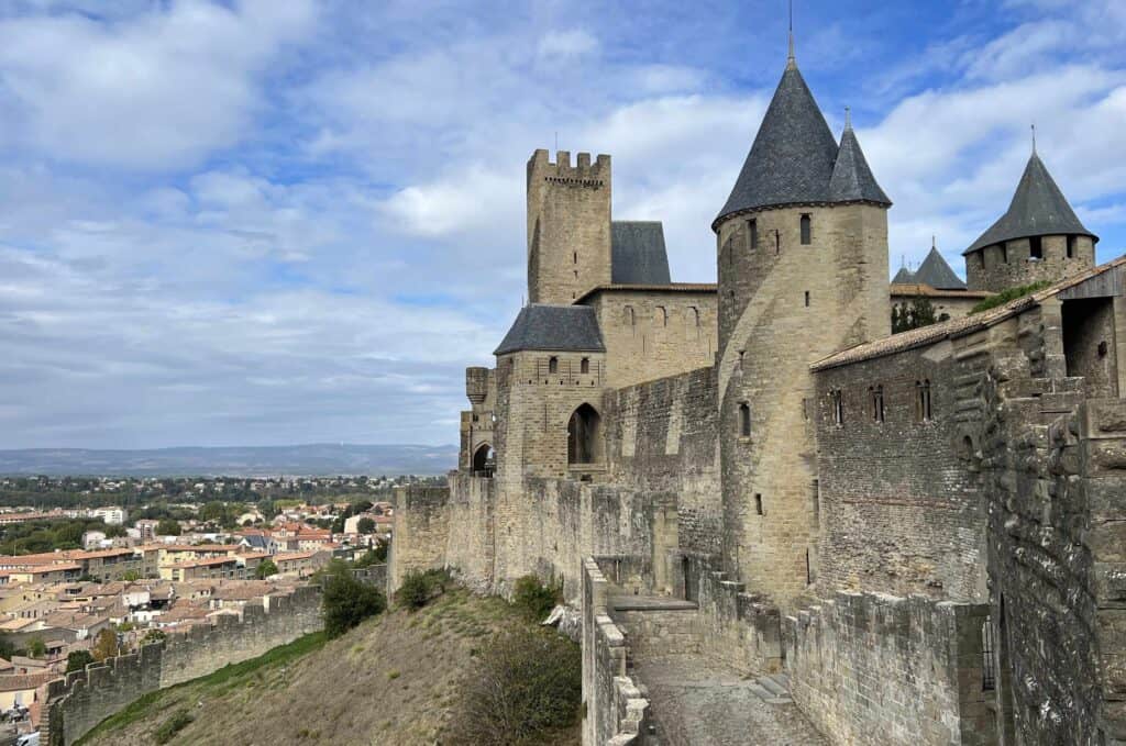 Side view of the stone castle in the walled city of Carcassonne with the new city beyond it.