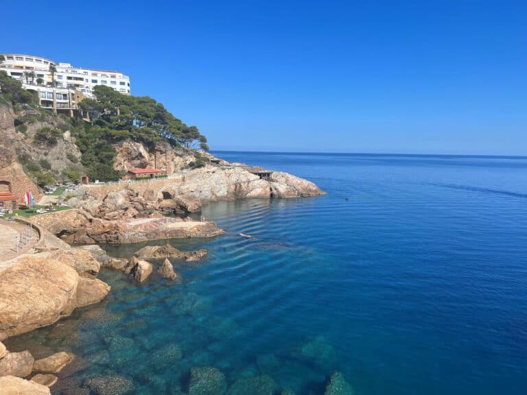 The rocky coastline of the Mediterranean Sea near Begur on the left with the clear blue water on the right.