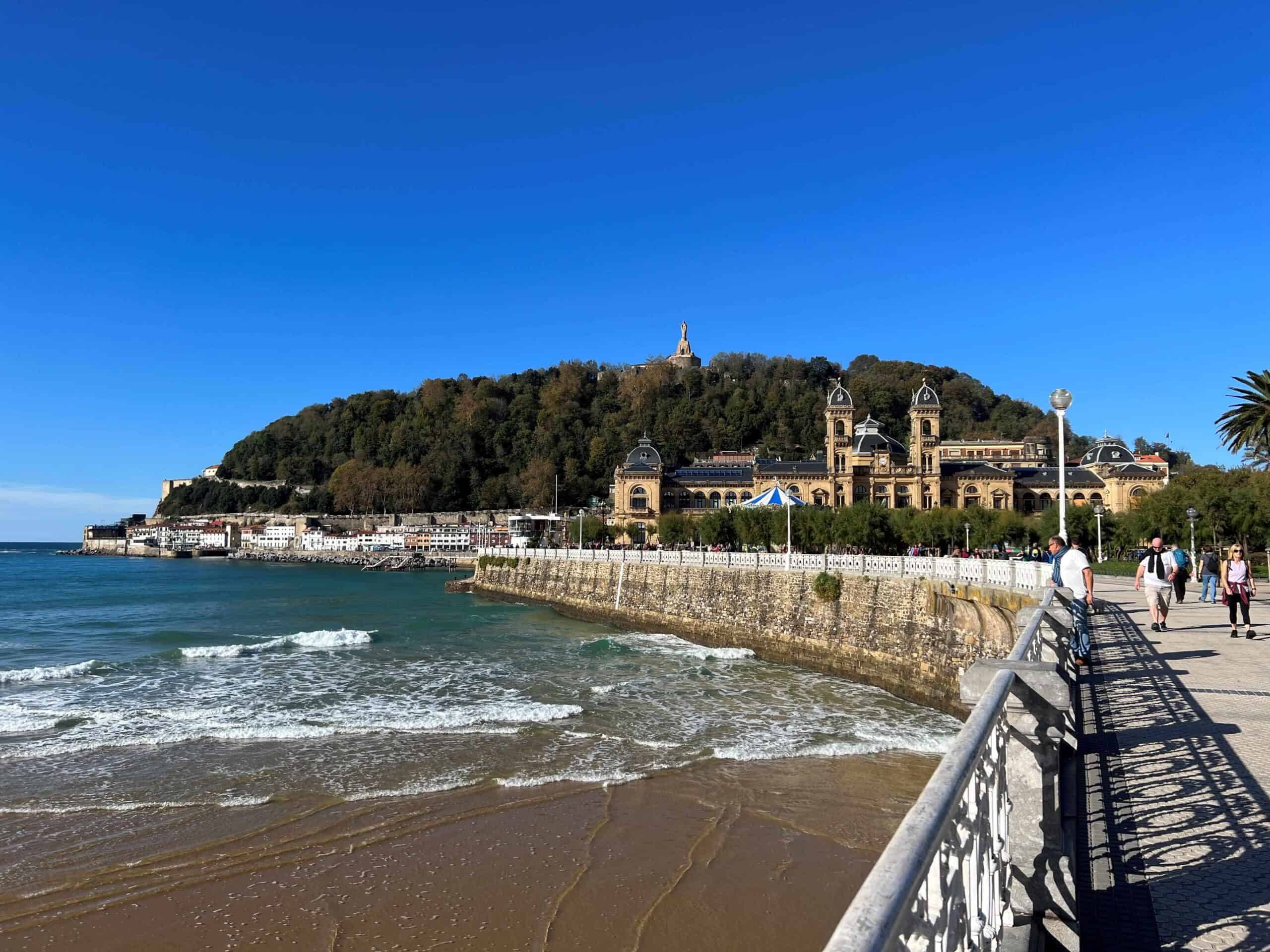 Waterfront at San Sebastian with beach on left and a walkway to the right that leads into old town.