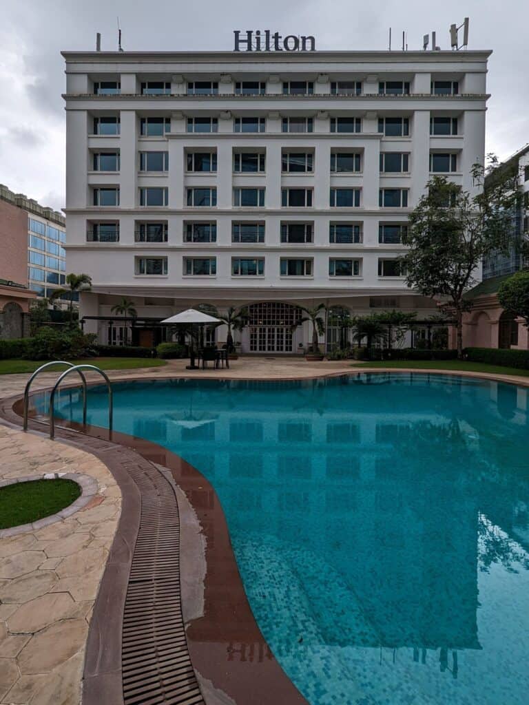 Exterior of the Hilton Hotel near Mumbai Airport with the pool in the foreground.