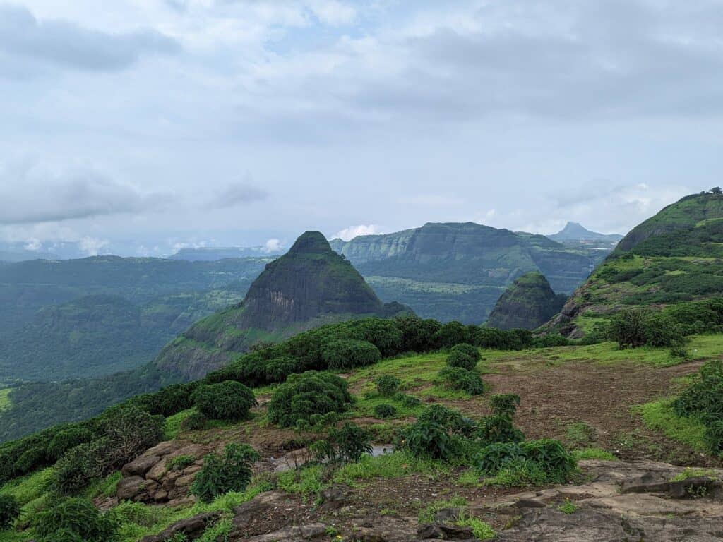 View of rolling green hills on a cloudy day in Lonavala from near Tiger Point.