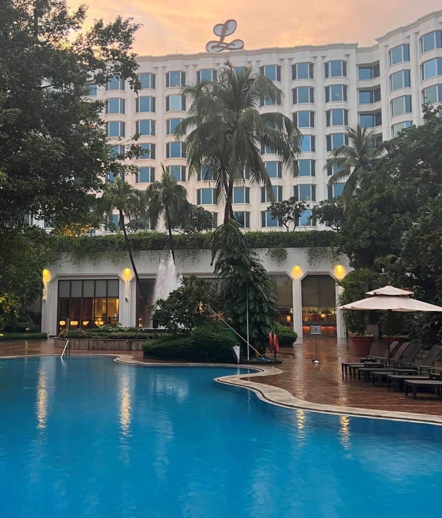 Outside view of the Leela hotel near Mumbai airport from the back of the hotel with the pool in the foreground.